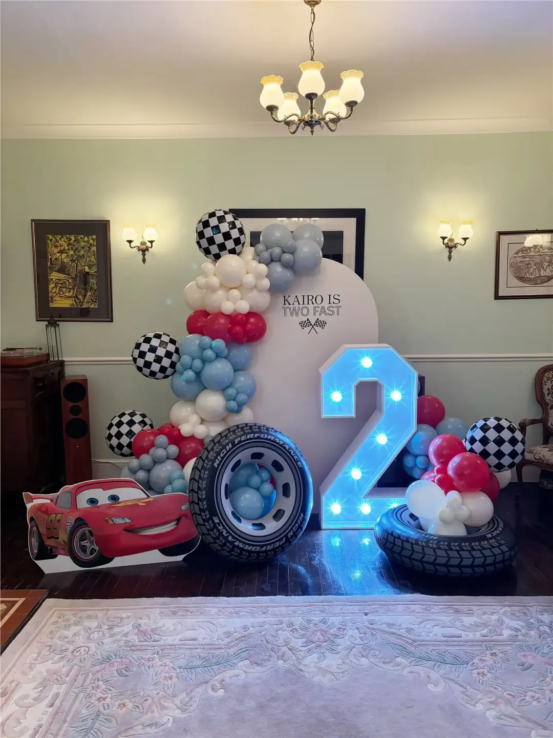 Cars-themed balloon display with illuminated number two