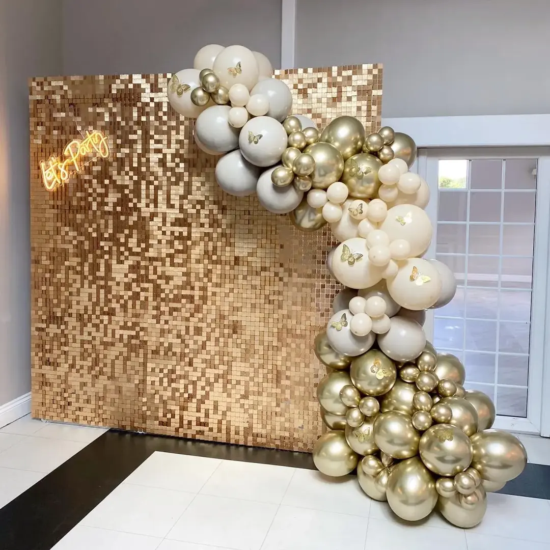 Gold sequin feature wall with champagne balloon garland